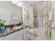 Bright bathroom features white vanity, a granite countertop, updated fixtures and a shower-tub combination at 1396 Riley Cir, Deland, FL 32724