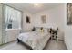 Neutral bedroom offers a comfortable bed, stylish side tables, soft carpet, and natural light from the window at 1396 Riley Cir, Deland, FL 32724