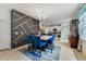 Stylish dining room with blue chairs, decorative wall, and open view to the modern kitchen at 1396 Riley Cir, Deland, FL 32724