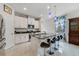 Bright kitchen boasts white cabinets, a black marble countertop island, and stylish pendant lighting at 1396 Riley Cir, Deland, FL 32724