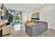 Cozy living room with a large sectional sofa, modern artwork, and sliding glass doors to the backyard at 1396 Riley Cir, Deland, FL 32724