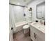 Bright bathroom featuring a tub and shower combo, modern fixtures, and a sleek vanity at 14 Fir Trail Way, Ocala, FL 34472