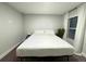 Cozy bedroom with a full bed, soft lighting, and a bright window with blinds at 14 Fir Trail Way, Ocala, FL 34472