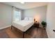 Comfortable bedroom showcasing a queen bed, ambient lighting, and stylish wood floors at 14 Fir Trail Way, Ocala, FL 34472