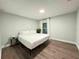Inviting bedroom with a full bed, wood flooring, and a calming ambiance at 14 Fir Trail Way, Ocala, FL 34472