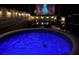 Outdoor space featuring a hot tub and entertaining space with a projector screen at 14 Fir Trail Way, Ocala, FL 34472