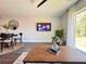 Bright living room featuring modern decor, a flat-screen TV, and sliding glass doors to the outside at 14 Fir Trail Way, Ocala, FL 34472