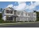 Charming townhome featuring neutral siding, black shutters, covered entry and manicured landscaping at 1403 Mount Royal Dr, St Cloud, FL 34771