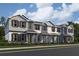 Charming new townhome with Hardie board siding, black shutters, covered entry and professional landscaping at 1403 Mount Royal Dr, St Cloud, FL 34771