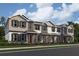 Charming new townhome with Hardie board siding, black shutters, covered entry and professional landscaping at 1403 Mount Royal Dr, St Cloud, FL 34771