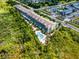 Aerial view shows the community, lush landscaping, and the sparkling community pool at 14200 Avalon Rd # 409, Winter Garden, FL 34787