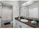 Bathroom featuring a vanity with a dark countertop, a shower/tub combo, and nautical themed décor at 14200 Avalon Rd # 409, Winter Garden, FL 34787
