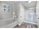 Clean bathroom featuring a soaking tub, a glass-enclosed shower, and neutral tones for a serene experience at 14200 Avalon Rd # 409, Winter Garden, FL 34787