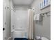 Bathroom showcasing a shower and tub with white tile, and a blue rug and white shower curtain at 14200 Avalon Rd # 409, Winter Garden, FL 34787