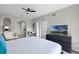 Stylish bedroom with a modern entertainment setup, a cozy seating area, and an ensuite bathroom for added convenience at 14200 Avalon Rd # 409, Winter Garden, FL 34787