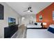 Spacious bedroom with two beds, modern entertainment features, and a view into the bathroom and other living spaces at 14200 Avalon Rd # 409, Winter Garden, FL 34787
