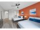 Spacious bedroom with gray wood floors, two queen beds, stylish décor and an en suite bathroom at 14200 Avalon Rd # 409, Winter Garden, FL 34787