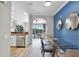 Inviting view into an open floor plan featuring the dining room, living room with access to the balcony, and kitchen at 14200 Avalon Rd # 409, Winter Garden, FL 34787
