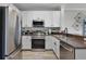 Well-equipped kitchen featuring stainless steel appliances, white cabinets, and granite countertops at 14200 Avalon Rd # 409, Winter Garden, FL 34787