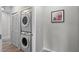 Laundry room with stacked washer and dryer, storage closet, and light gray paint at 14200 Avalon Rd # 409, Winter Garden, FL 34787