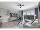 Elegant living room with plush seating, stylish decor, and a glass sliding door leading to a private balcony at 14200 Avalon Rd # 409, Winter Garden, FL 34787