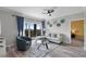 Stylish living room offers comfortable seating, a ceiling fan, balcony access, and elegant floral wall decor at 14200 Avalon Rd # 409, Winter Garden, FL 34787