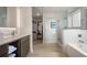 Bathroom with dual sinks, walk-in closet, glass shower and separate soaking tub at 14501 Grove Resort Ave # 3636, Winter Garden, FL 34787