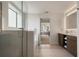Bright bathroom with a glass-enclosed shower and double sink vanity with towel storage at 14501 Grove Resort Ave # 3636, Winter Garden, FL 34787