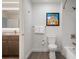 Well-lit bathroom with vanity, toilet, tub/shower, modern fixtures, and artistic wall decor at 14501 Grove Resort Ave # 3636, Winter Garden, FL 34787