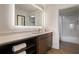 Modern bathroom featuring a large, illuminated mirror, stylish vanity, and a shower/tub combination at 14501 Grove Resort Ave # 3636, Winter Garden, FL 34787