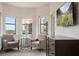 Bright bedroom with seating, large windows with a view, and a mounted television at 14501 Grove Resort Ave # 3636, Winter Garden, FL 34787