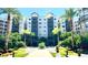 Building with multiple floors, balconies, and lush landscaping in the foreground at 14501 Grove Resort Ave # 3636, Winter Garden, FL 34787