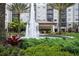 Exterior of building featuring a fountain, lush landscaping, and a grand entrance for residents and guests at 14501 Grove Resort Ave # 3636, Winter Garden, FL 34787