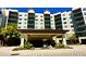 Beautiful multi-story condominium building with welcoming entrance and lush landscaping at 14501 Grove Resort Ave # 3636, Winter Garden, FL 34787