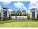 The Grove Resort and Waterpark entrance featuring beautiful landscaping, architectural towers, and mature palm trees at 14501 Grove Resort Ave # 3636, Winter Garden, FL 34787