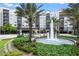 Stunning exterior view of a multi-story resort building with fountain, lush landscaping, and well-maintained lawns at 14501 Grove Resort Ave # 3636, Winter Garden, FL 34787
