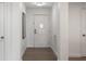 Bright hallway with neutral tones and wood flooring leads to various rooms in the home at 14501 Grove Resort Ave # 3636, Winter Garden, FL 34787