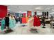 Boutique with clothing racks displaying colorful resort wear, hats, and accessories for sale in a bright and airy space at 14501 Grove Resort Ave # 3636, Winter Garden, FL 34787