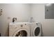 Efficient laundry room with modern washer and dryer, neatly organized for convenience at 14501 Grove Resort Ave # 3636, Winter Garden, FL 34787