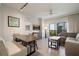 Spacious living room with contemporary decor, a dining area, and a balcony with a view at 14501 Grove Resort Ave # 3636, Winter Garden, FL 34787