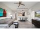 Open concept living area with modern decor, a couch, a TV and a view to the kitchen and dining area at 14501 Grove Resort Ave # 3636, Winter Garden, FL 34787