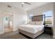 Comfortable main bedroom with large bed, two windows, and a view into the bathroom at 14501 Grove Resort Ave # 3636, Winter Garden, FL 34787