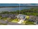 Aerial view of two-story home on the lake with lush green landscape, and gray roof at 16410 Good Hearth Blvd, Clermont, FL 34711