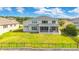 Spacious backyard featuring a lush lawn, a screened-in porch, and a secure fence at 16410 Good Hearth Blvd, Clermont, FL 34711