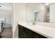 Modern bathroom with quartz countertop, dark cabinets, and a large vanity mirror at 16410 Good Hearth Blvd, Clermont, FL 34711