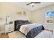 Cozy bedroom featuring a comfortable bed, soft rug, and a bright window at 16410 Good Hearth Blvd, Clermont, FL 34711