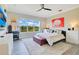 Stylish bedroom with a large window offering natural light, a plush rug, and tasteful décor at 16410 Good Hearth Blvd, Clermont, FL 34711