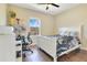 Bright bedroom featuring a white frame bed, dark wood flooring and modern decor at 16410 Good Hearth Blvd, Clermont, FL 34711