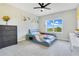 Well-lit bedroom with a unique bed frame and neutral decor with a gray carpet at 16410 Good Hearth Blvd, Clermont, FL 34711