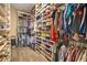 Spacious walk-in closet with custom shelving, hanging rods, and ample storage space for clothes and shoes at 16410 Good Hearth Blvd, Clermont, FL 34711